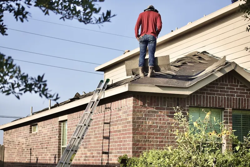 Professional roofer working on a residential roof in Sheldon Chase